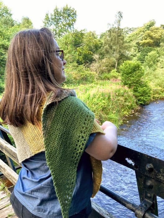 Louise looks over the river at Rosslyn Glen. her Gryer shawl is wrapped around her and over her right shoulder