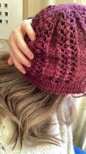 Louise wearing a burgundy lace detail hat